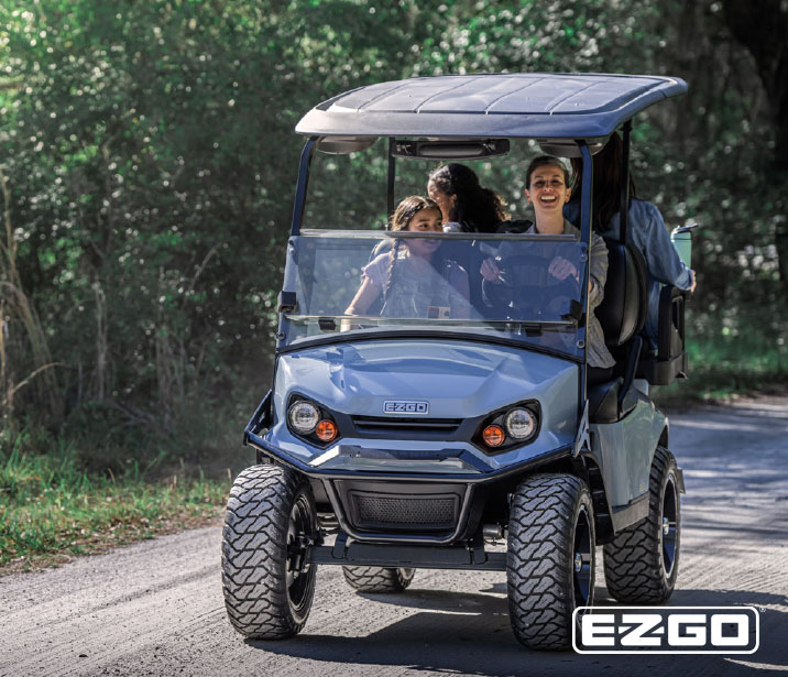 family driving down the road in a EZ-GO express S4